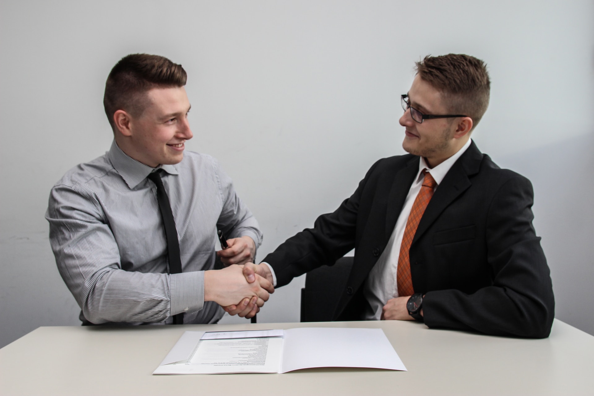 Two men shaking hands to agree on a job offer.Photo by Sebastian Herrmann on Unsplash
