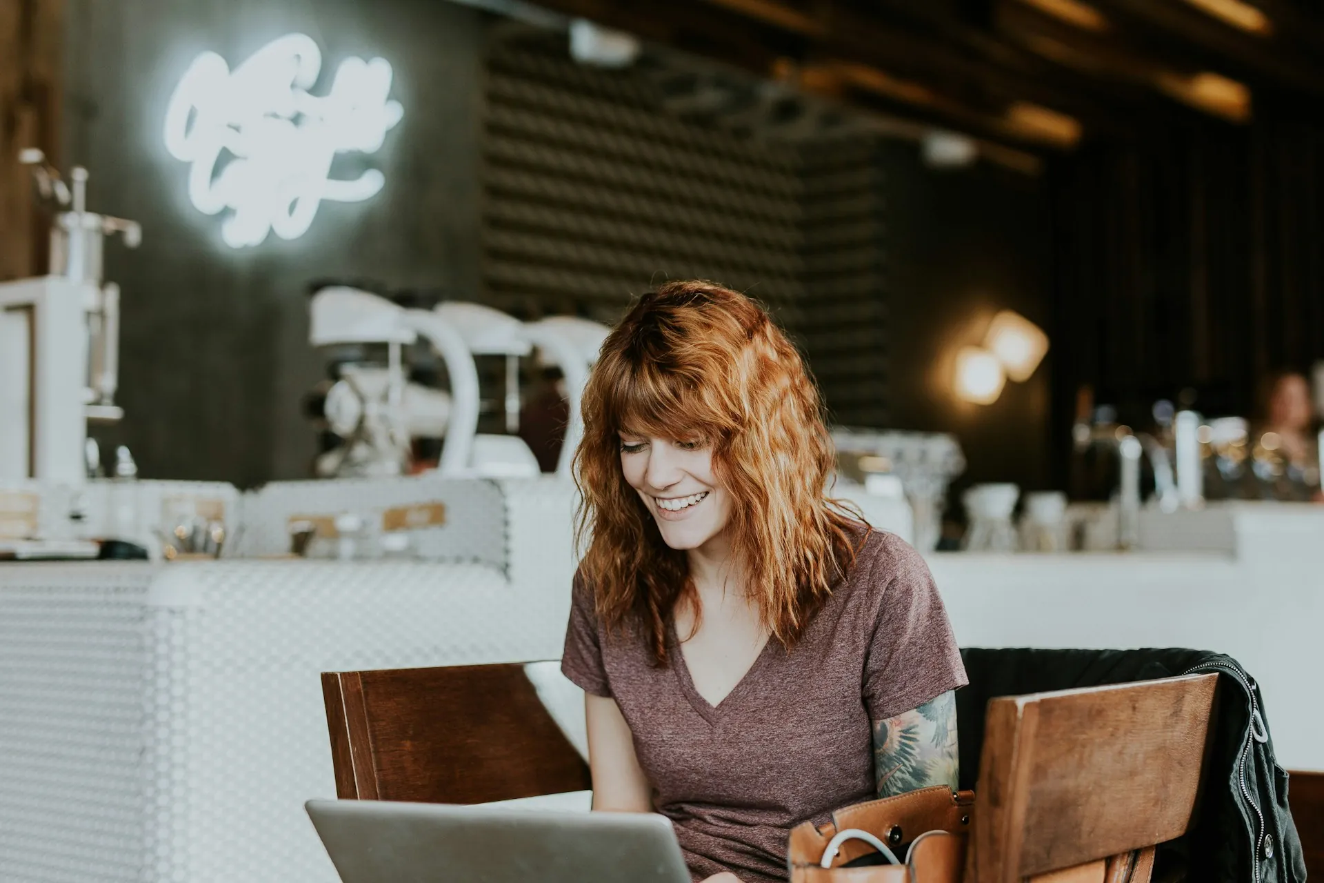 A female freelancer working at a cafe. Freelancer time management tips. Photo by Brooke Cagle on Unsplash