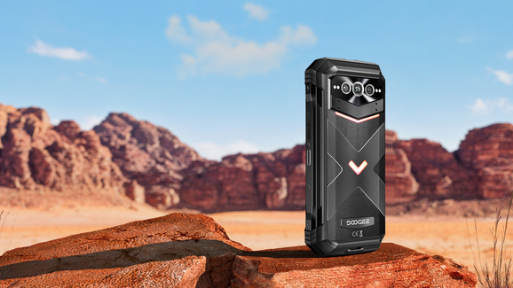 Doogee V Max Plus rugged phone on a rock with desert landscape in the background.