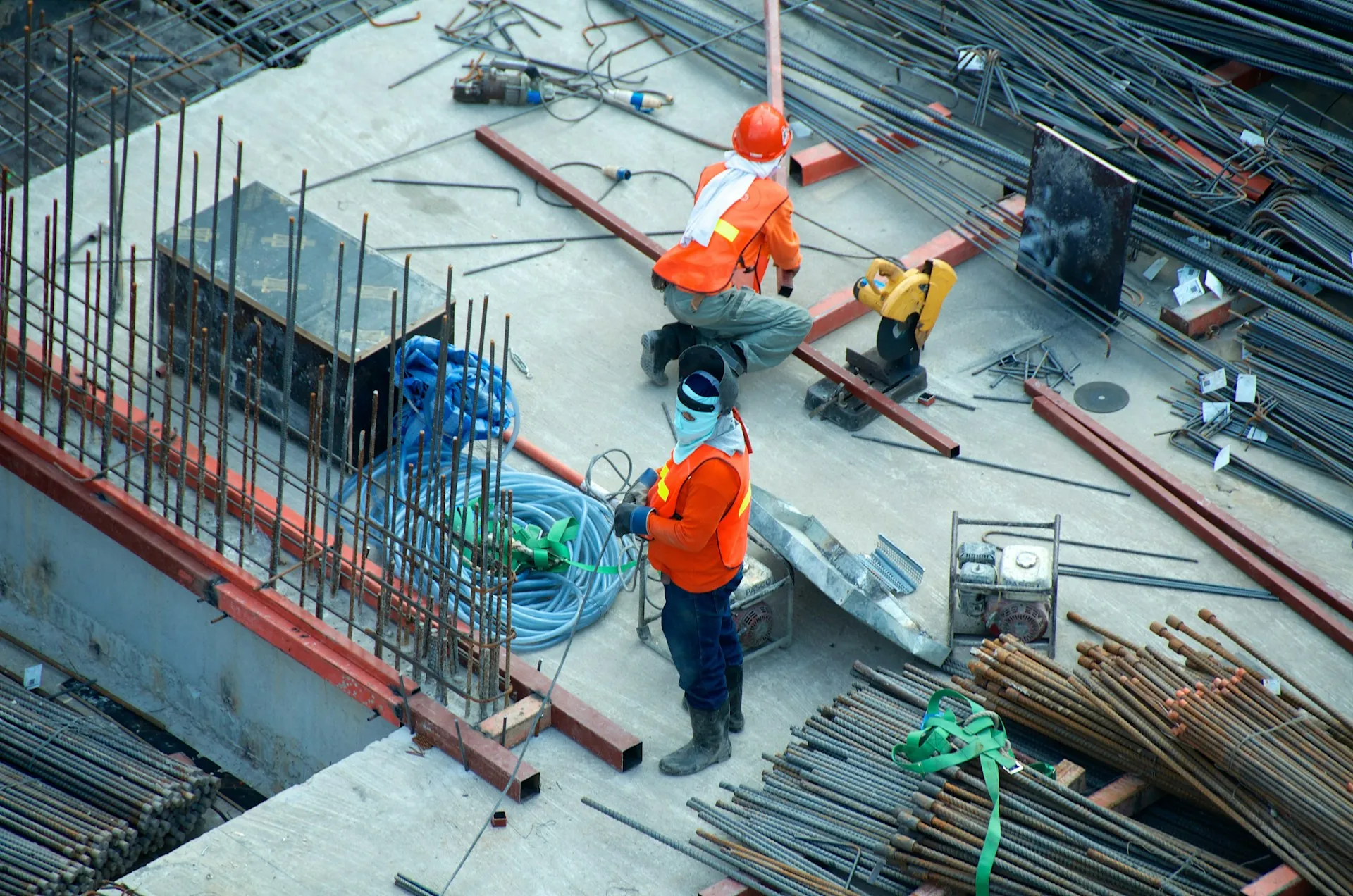 A group of construction workers working on various tasks at a construction site.