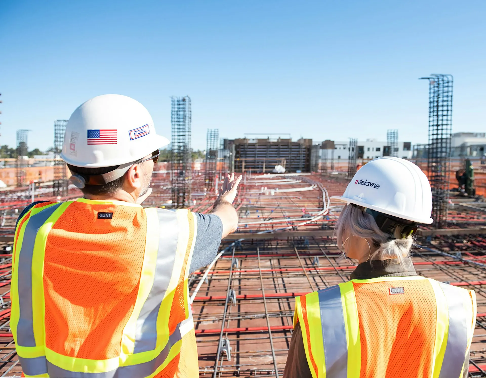 Two construction employees examining a construction site.