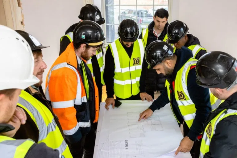 Construction Workers Looking at Drawings