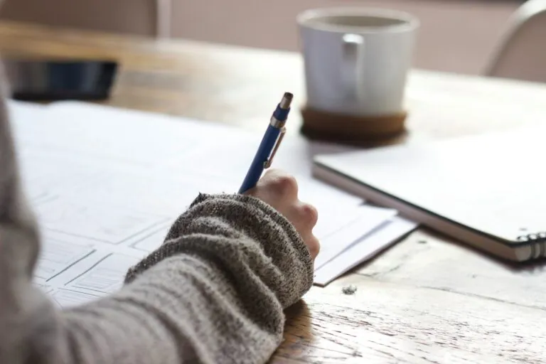 person writing at a desk